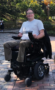 John Morris in his motorized wheelchair